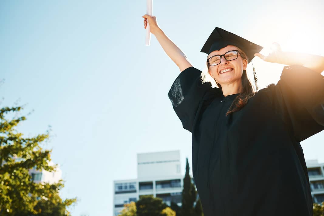 Woman, student and graduate for university achievement, scholarship or success for grades at the ca
